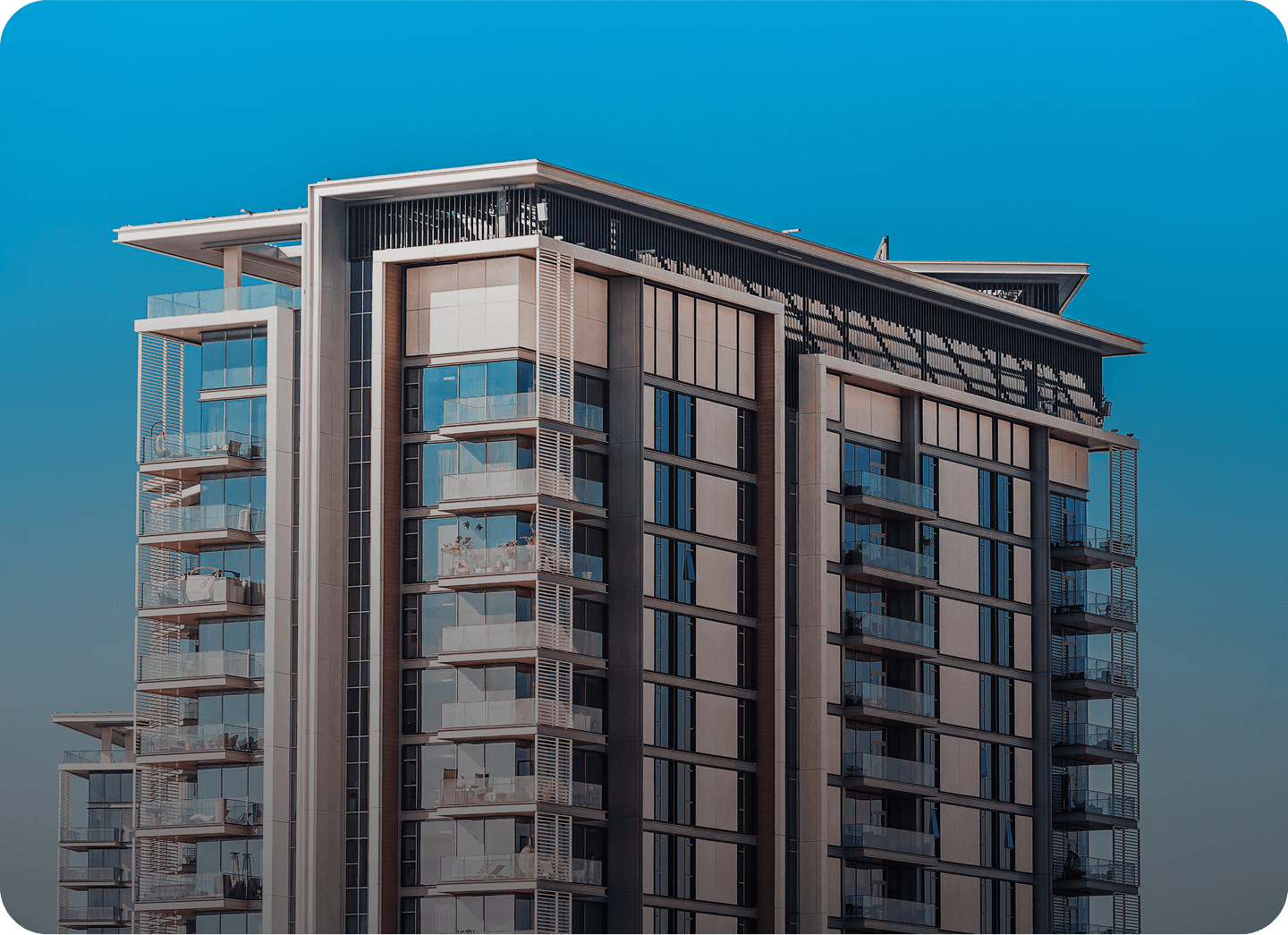 Modern glass apartment building on a sunny day